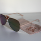 Sunglasses with rose-gold lenses and matte-rose arms.  Beer Eyed sunglasses cloth under sunglasses. Right-view